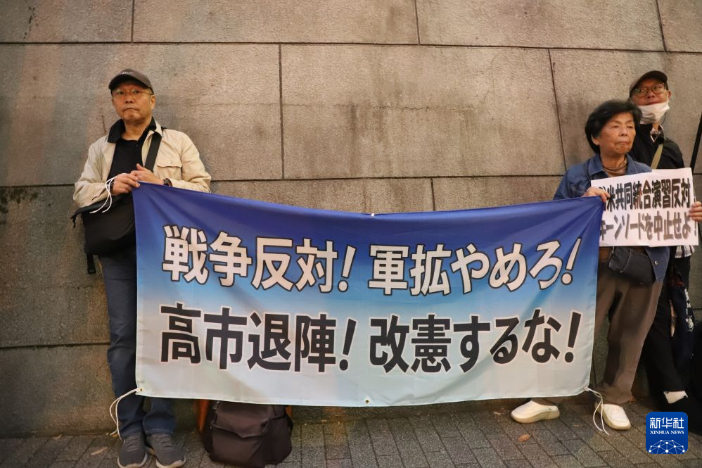 10月20日，在日本东京，抗议者手持横幅抗议。新华社记者 李子越 摄